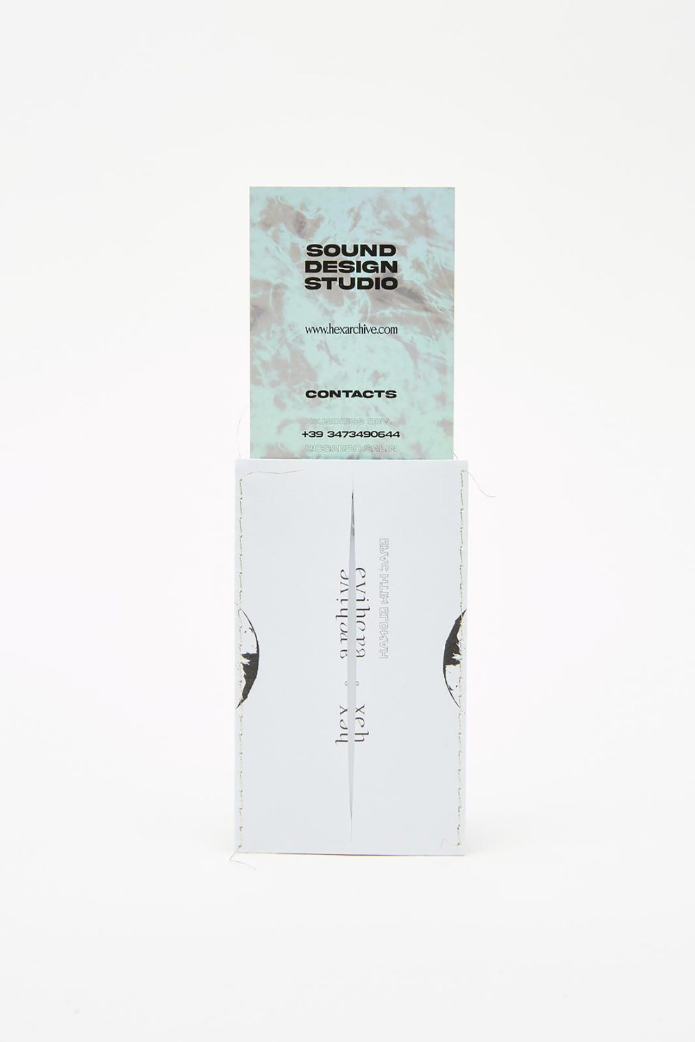 The front card, mint marbled, drawn from the stitched silver sleeve